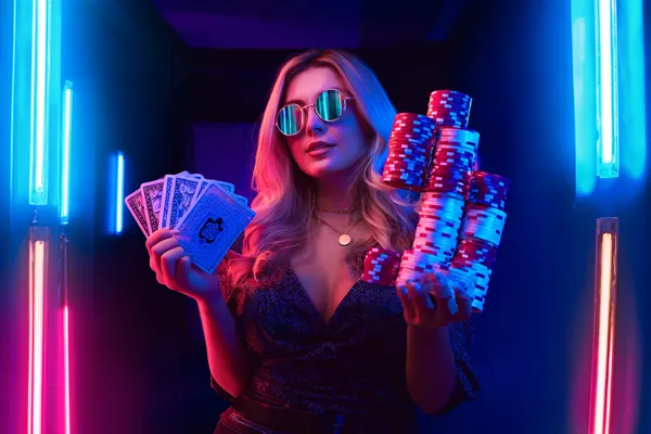 A glamorous woman holding casino chips in a neon-lit environment, representing the premium online casino atmosphere of PHCHARMS.
