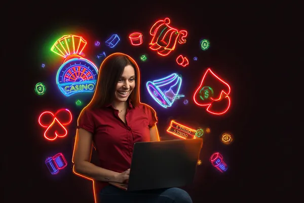 A woman smiling while playing online games on her laptop, surrounded by neon casino elements, showcasing PHCHARMS’s diverse game collection.