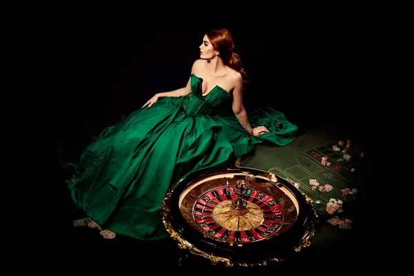 A woman in a luxurious green gown next to an ornate roulette wheel, capturing the upscale casino mood of PHCHARMS.