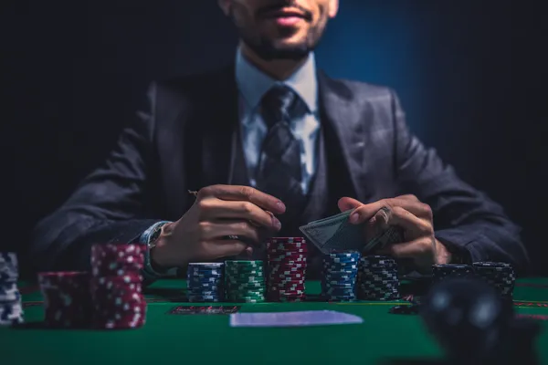 A confident dealer surrounded by casino chips inviting players to access their PHCHARMS account, reflecting quick and easy login options.